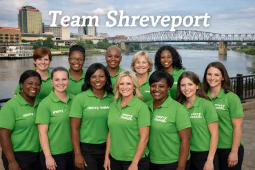merry maids shreveport team posing by skyline